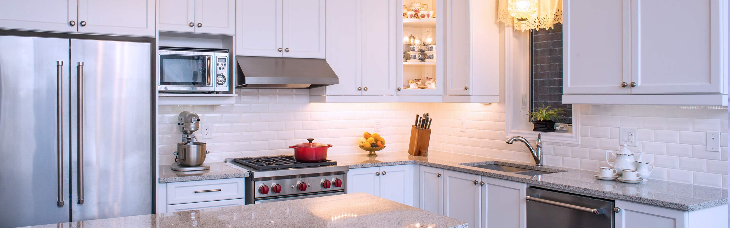 Kitchen with Gas Stove and White Cabinets